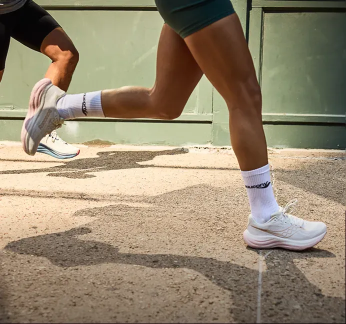 Runners mid-stride in Saucony shoes